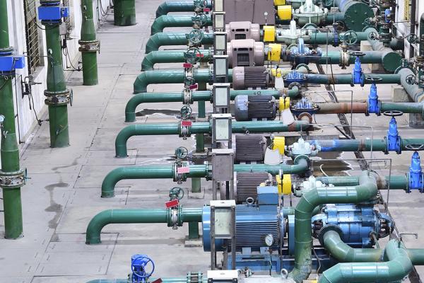 view of blue and green gas pipelines in a factory